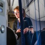 United Airlines flight attendants take a meal order onboard a plane