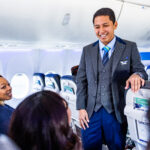 an alaska airlines flight attendant talking to passengers