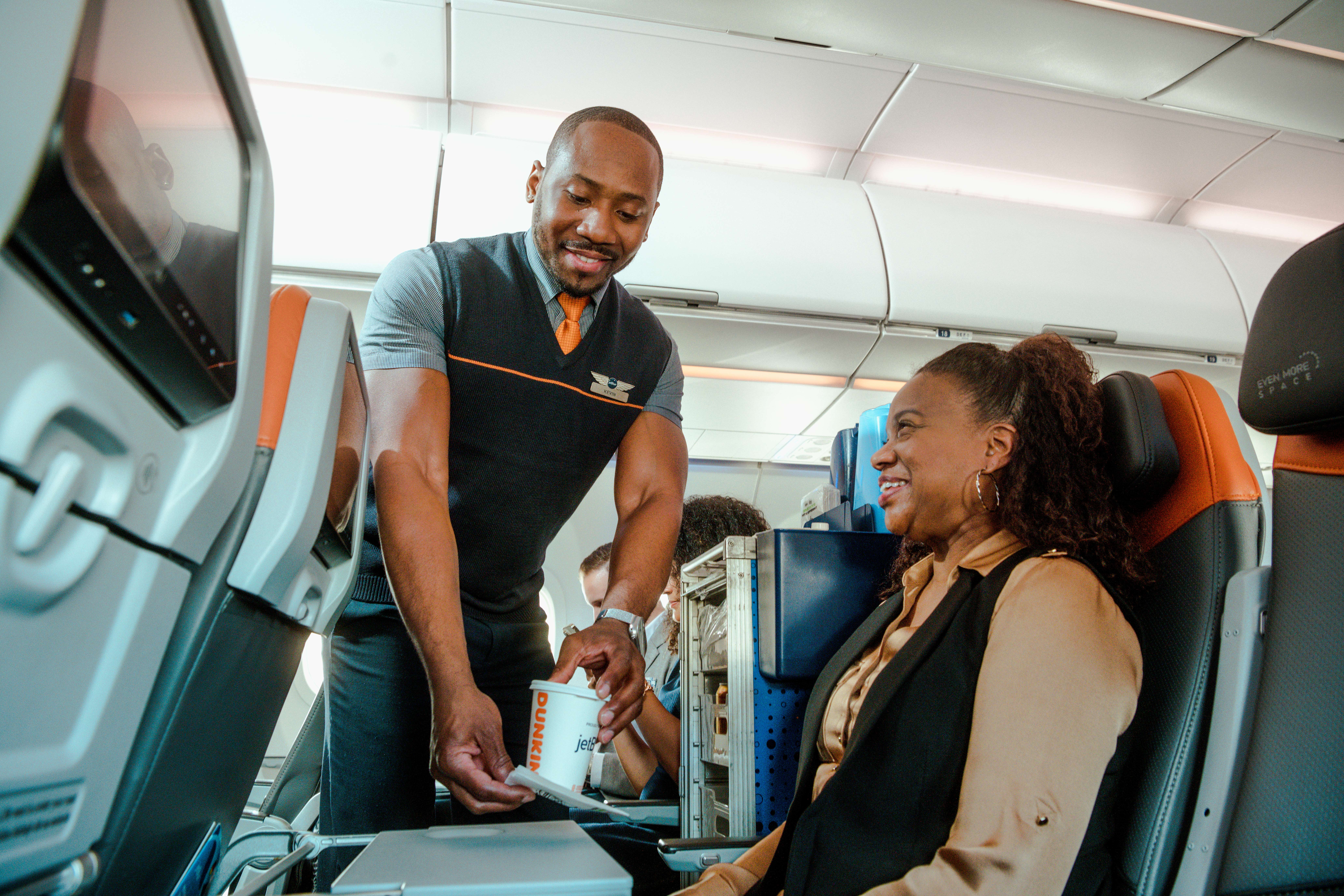 jetblue flight attendant serving a customer