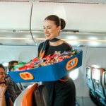a jetblue flight attendant serving snacks