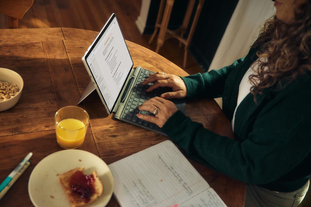 a woman typing on a laptop