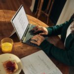 a woman typing on a laptop