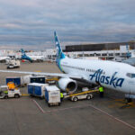 an alaska airlines boeing 737 parked at the gate