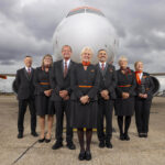 easyjet cabin crew standing in front of a plane
